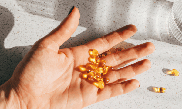 Image of photo of vitamin D capsules in a hand