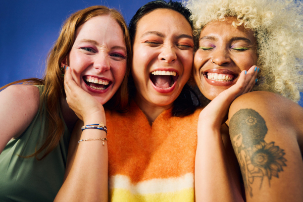 three women together laughing at the camera