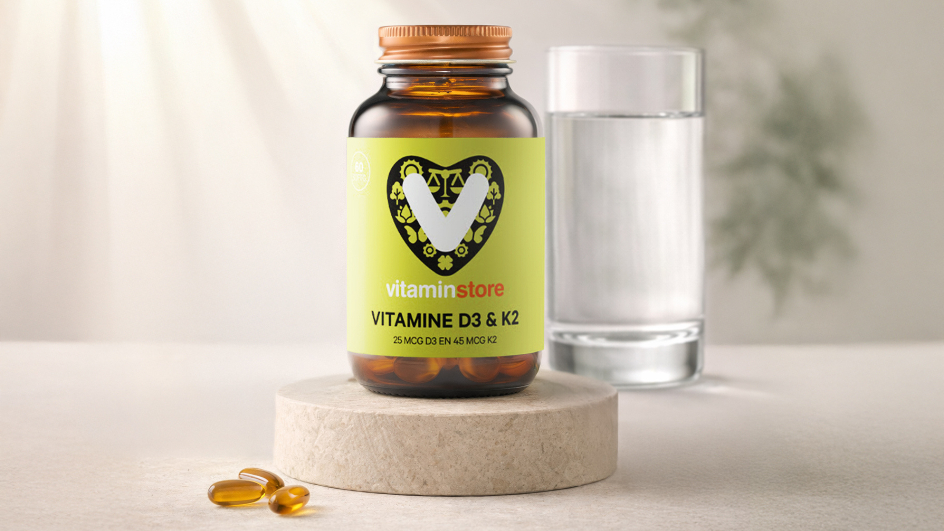 photo of a vitamin d and k supplement on a pedastal with a glass of water
